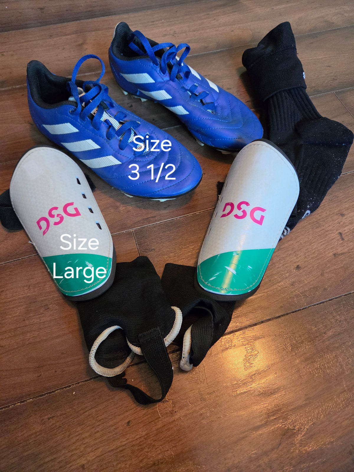 Seller #57 Soccer Lot. Size 3.5 cleats, large shin guards, and black socks