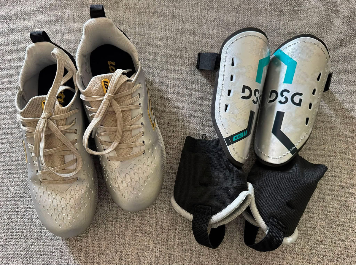 #92 Boys soccor cleats size 1 and medium shin guards both like new