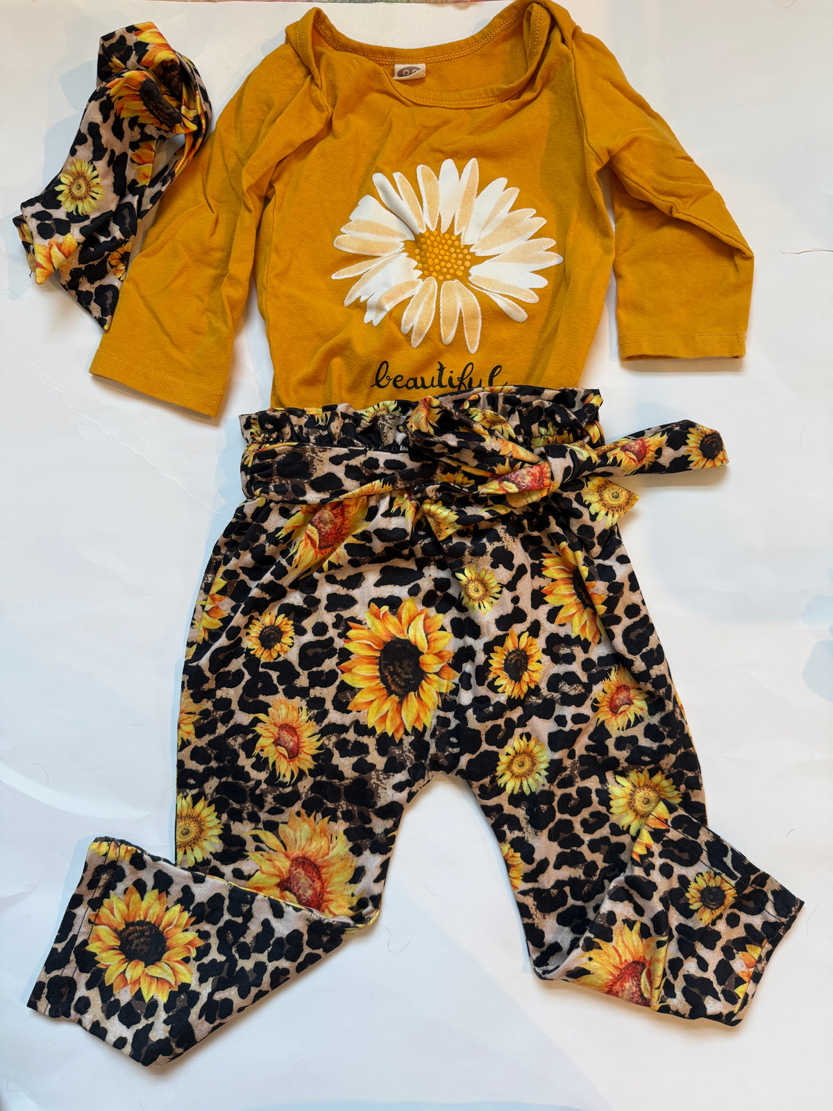 #170 Sunflower cheetah print pants with matching head tie and yellow shirt with flower and “beautiful” Girls 90 (fits like 18 months)
