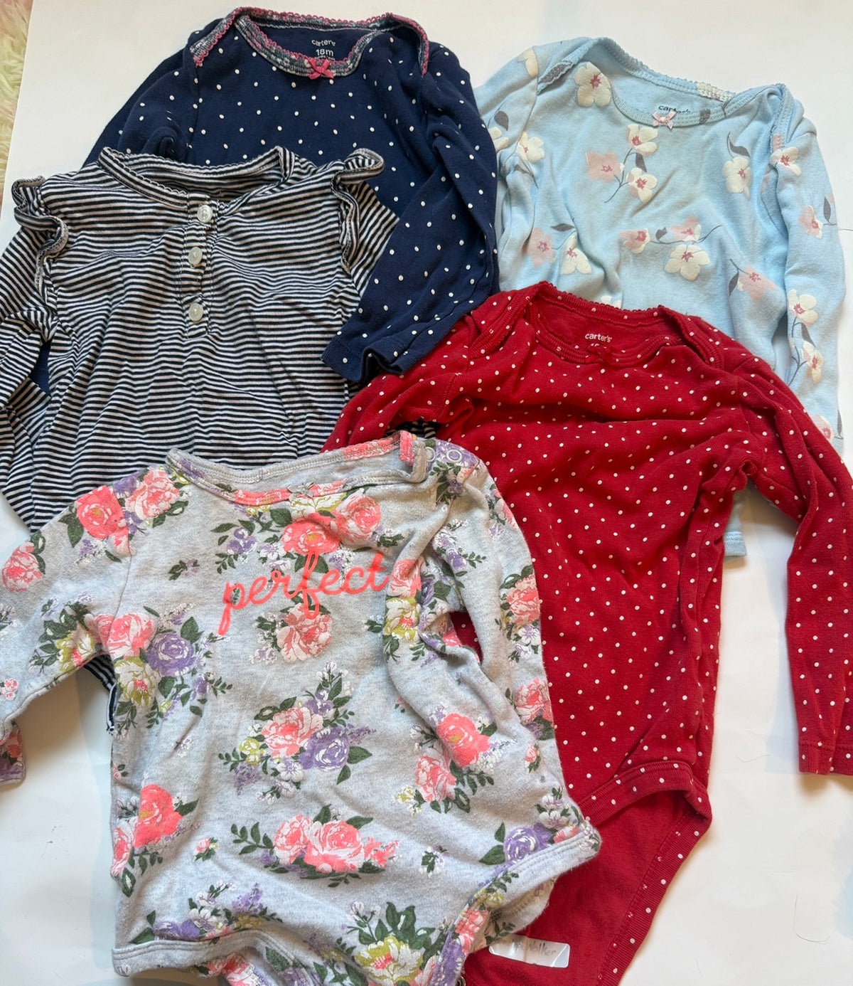 #170 Carters long sleeve body suit bundle (5) grey floral “perfect”, red and white polka dot, navy and white stripe with ruffle on sleeve and buttons in front, blue and white polka dot with floral piping, light blue with flowers. Girls 18 months