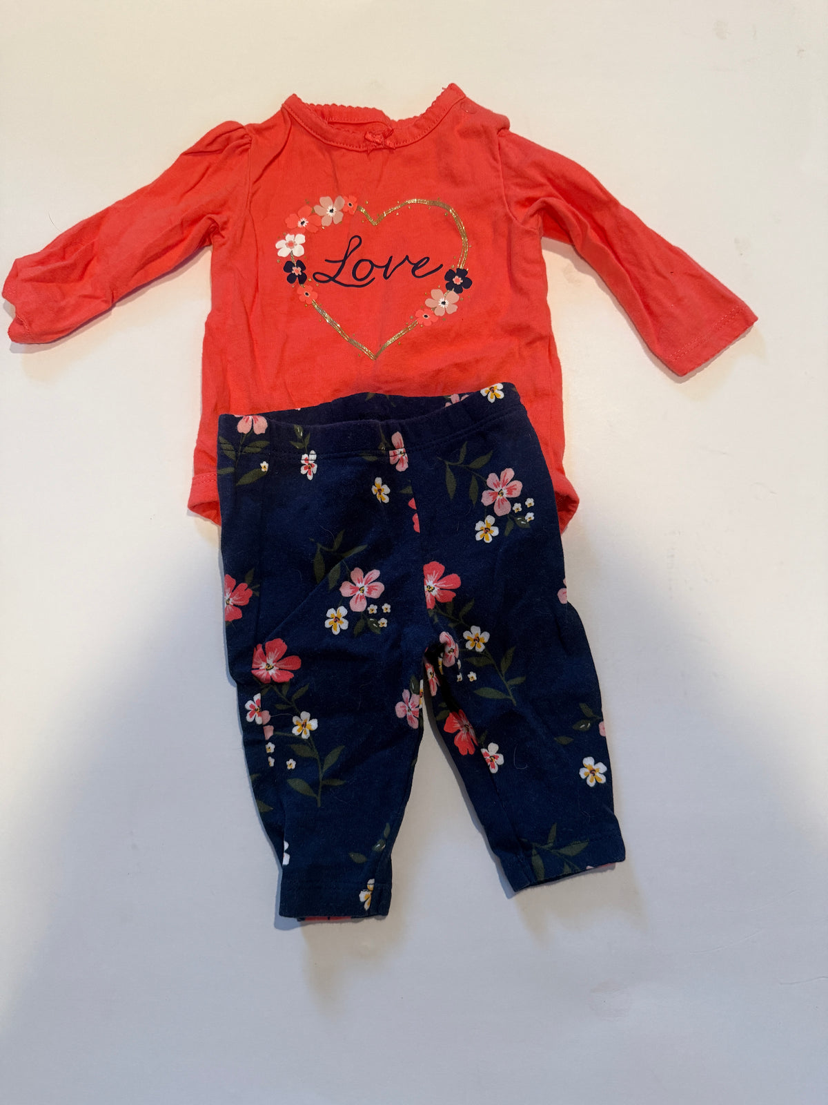 #170 Carters 2 piece outfit coral body suit with gold navy and white “love” and heart with matching navy floral pants girls 3 months