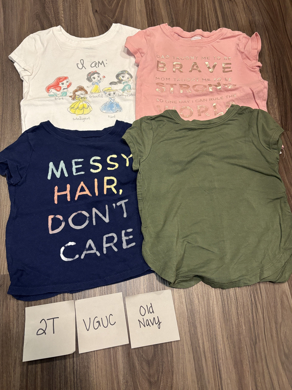 #138 - 2T Old Navy (4) VGUC Shirts (princess, messy hair, brave/strong, green)