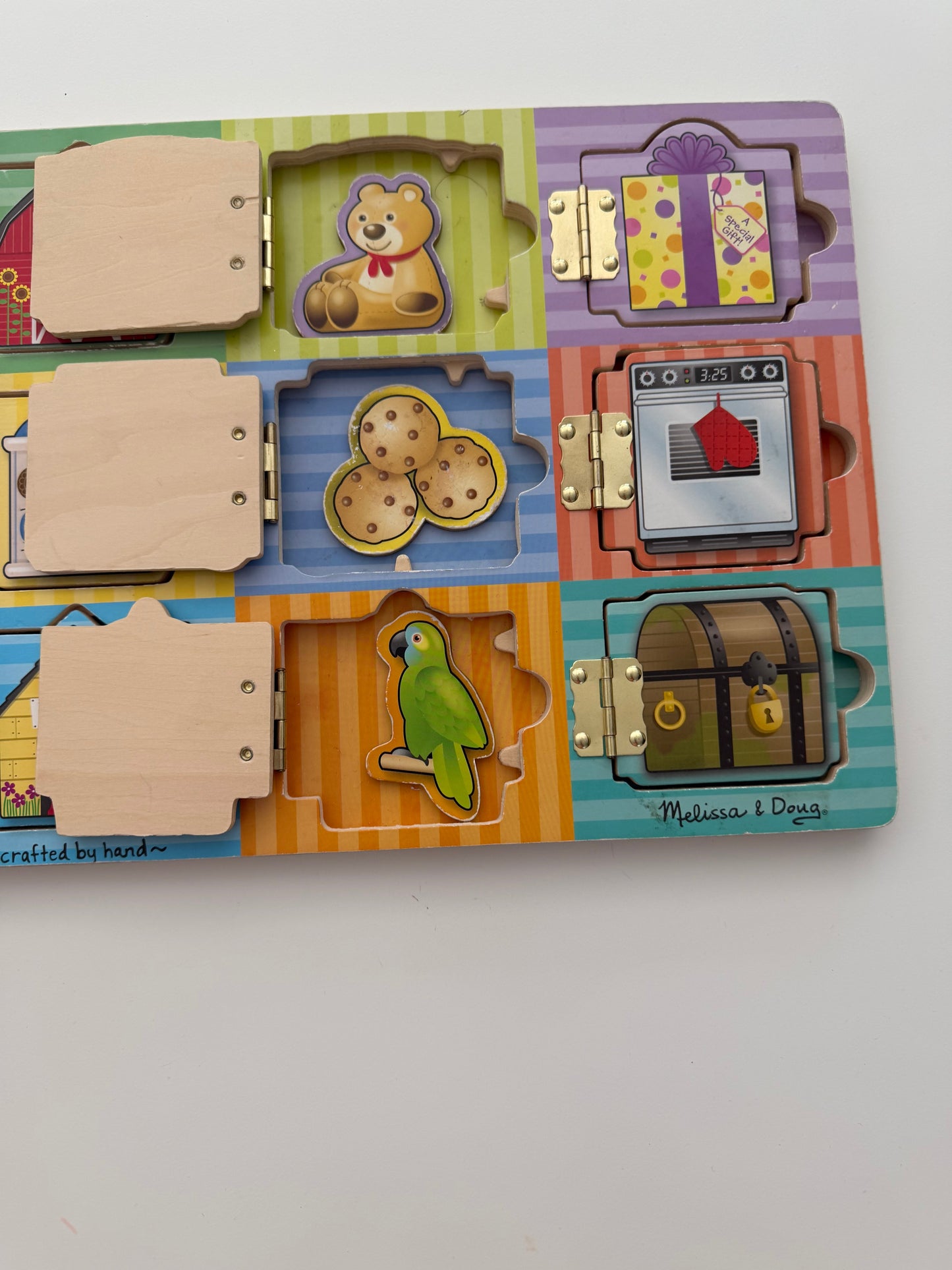 #117, Melissa & Doug Wooden hide Activity Board with Magnets