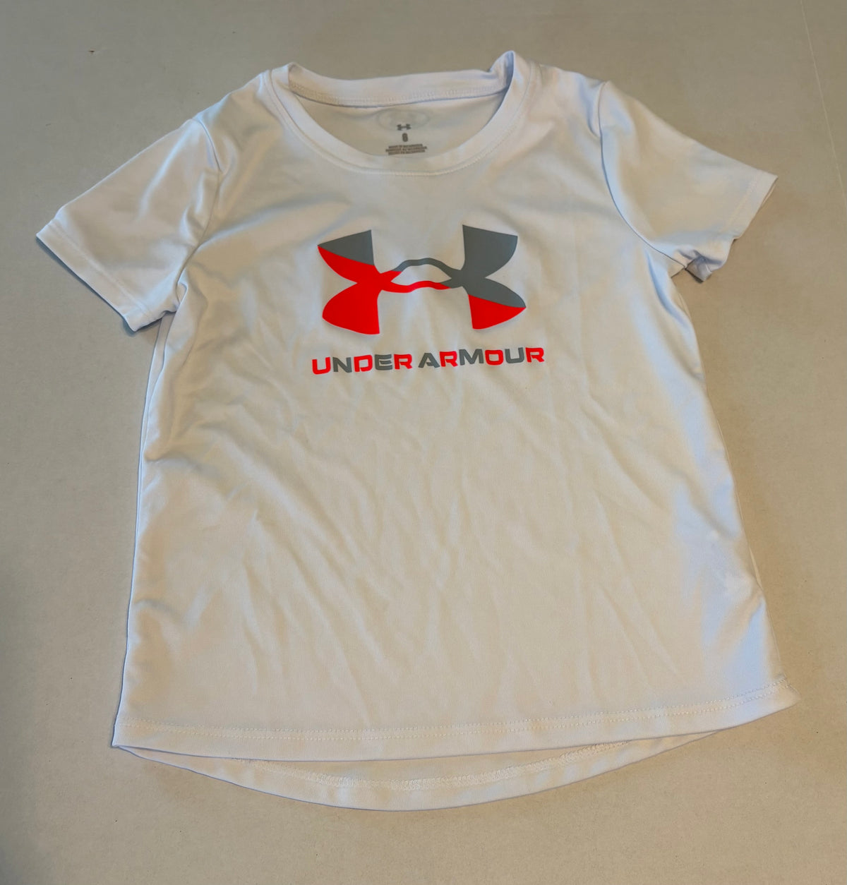 #25 Girls size 6 Under Armour white dri fit short sleeve t shirt
