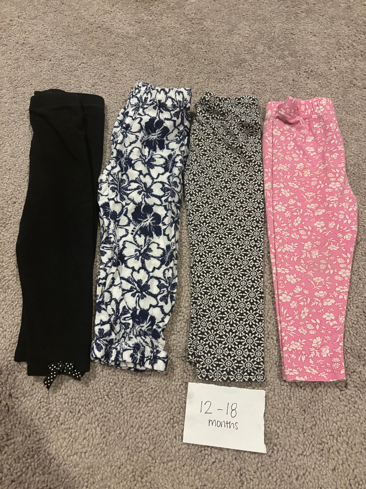 #138 - 12-18 Mo - VGUC 4 Pair Pants (black, navy/white, black/white, pink floral) - PU 45236