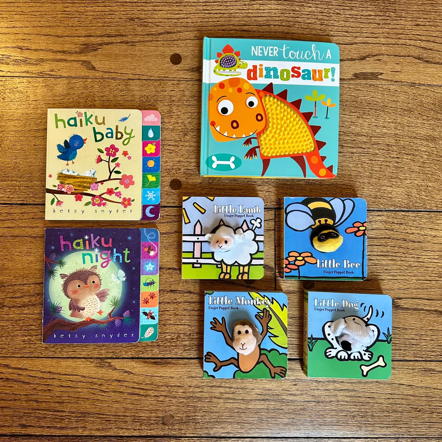 #95 Baby Board Books, set of 7, includes finger puppet books (4) and "Never Touch a Dinosaur"