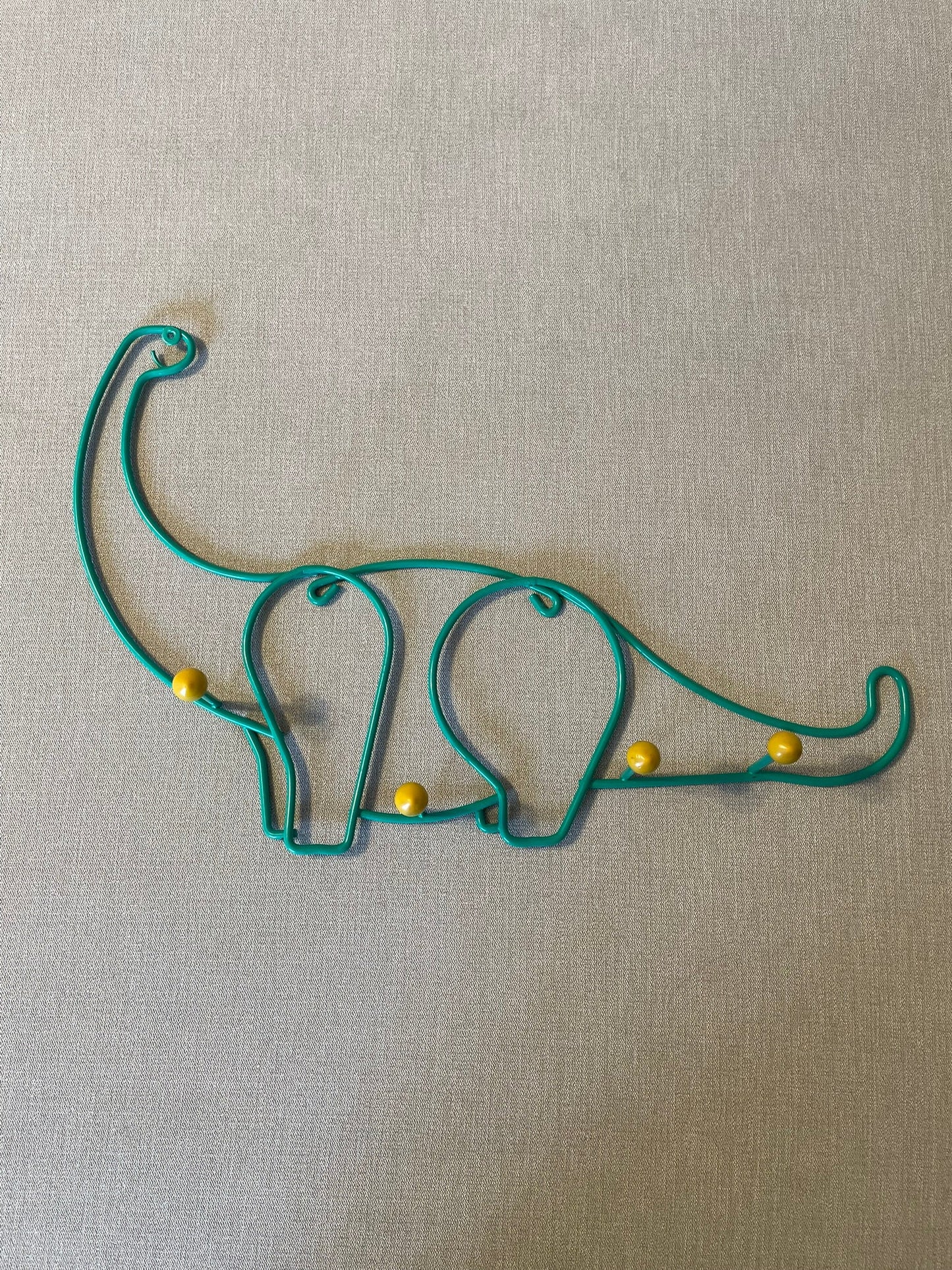 Seller #12 Vintage | Coated Metal | Green Dinosaur with Yellow Pegs | 17 inches x 11 inches