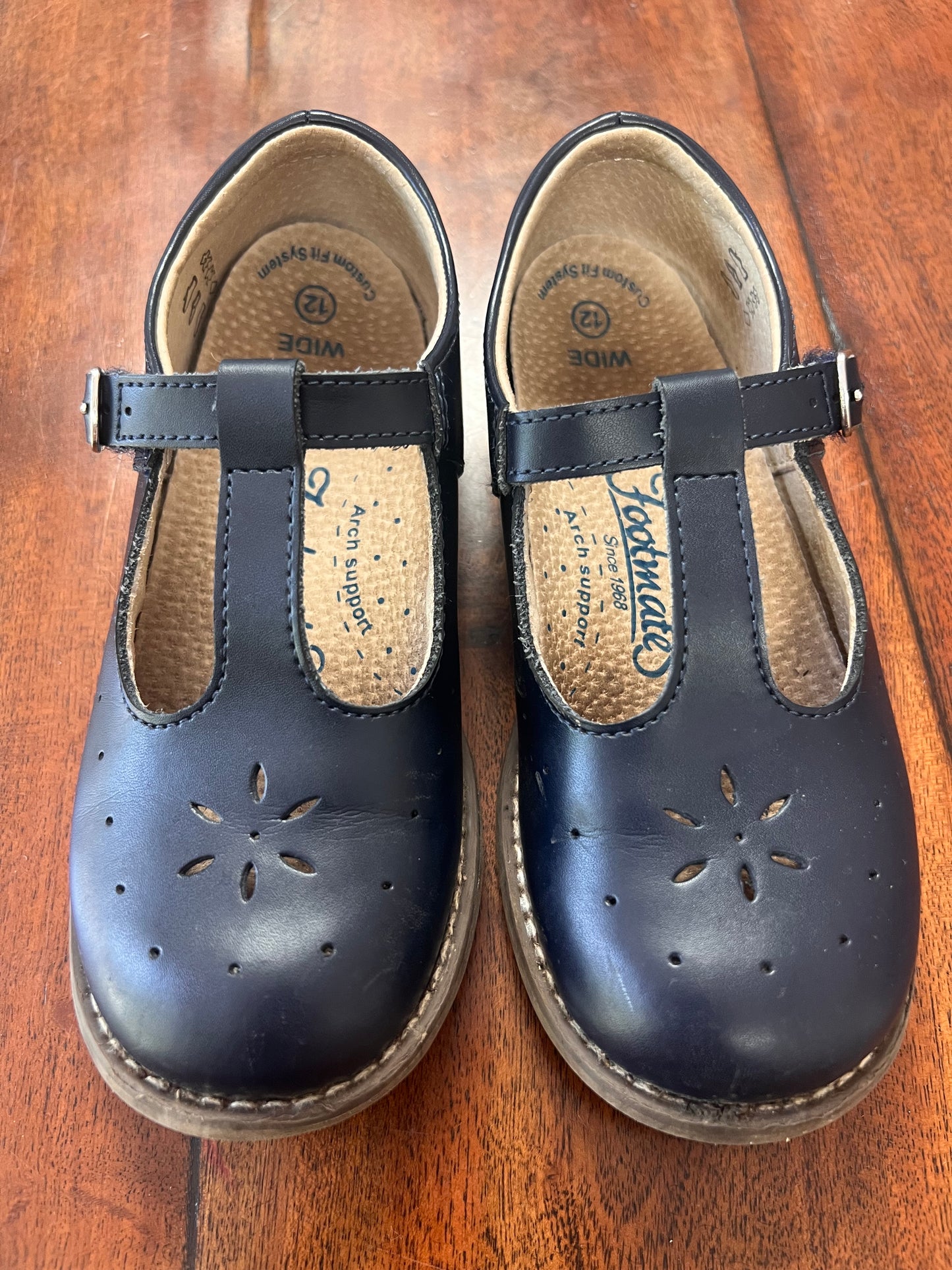 #66 size 12 wide Footmates girls navy t-strap shoes with easy velcro closure.