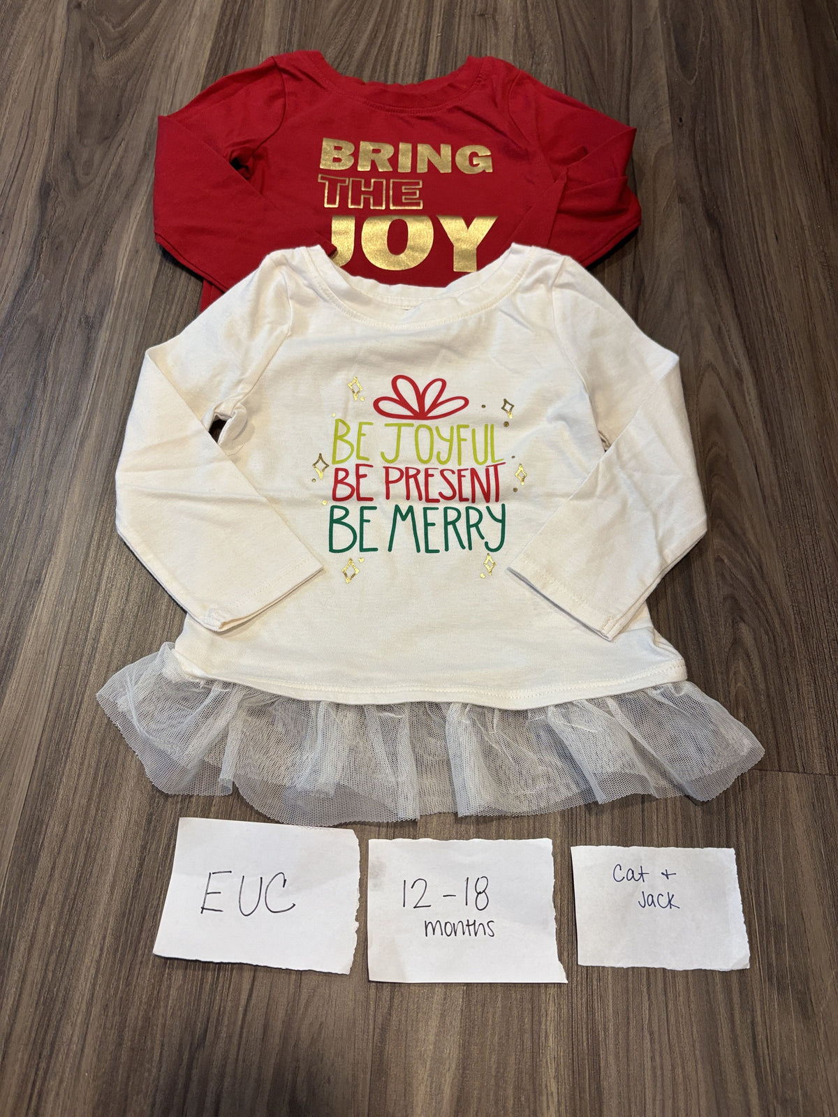 #138 - 12-18 Mo Cat & Jack EUC (2) Christmas Shirts (joy, merry)