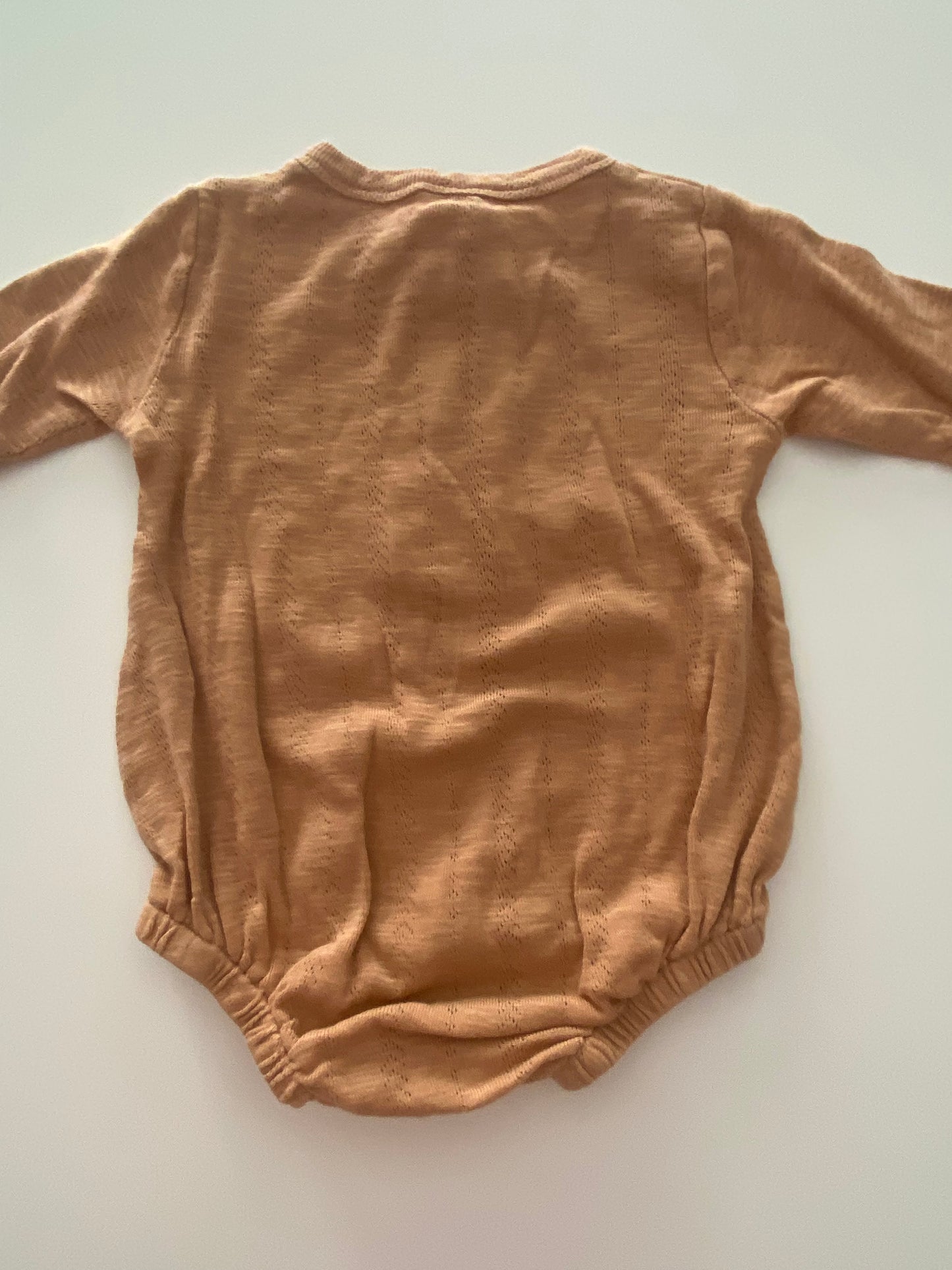 #117- Girls 12M, Kate Quinn tan onesie, VGUC