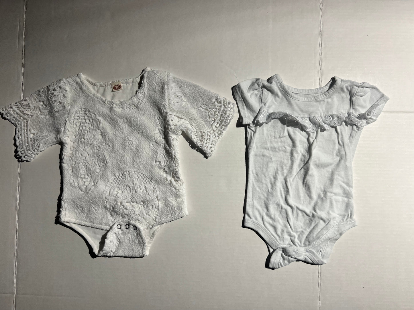 #100 Girls 12m White Onesies