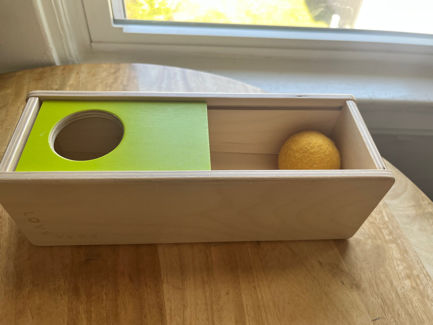 #97- Lovevery sliding top toy with felt ball