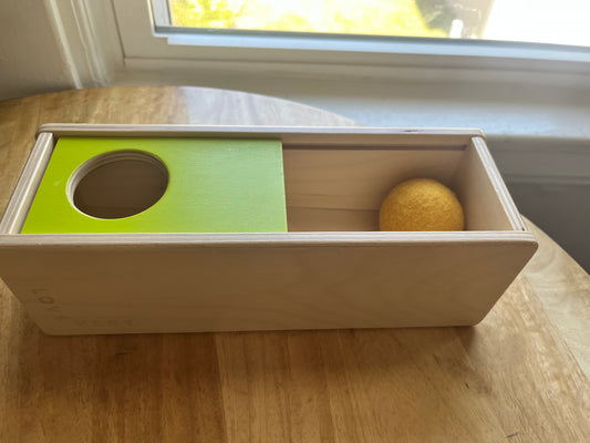 #97- Lovevery sliding top toy with felt ball