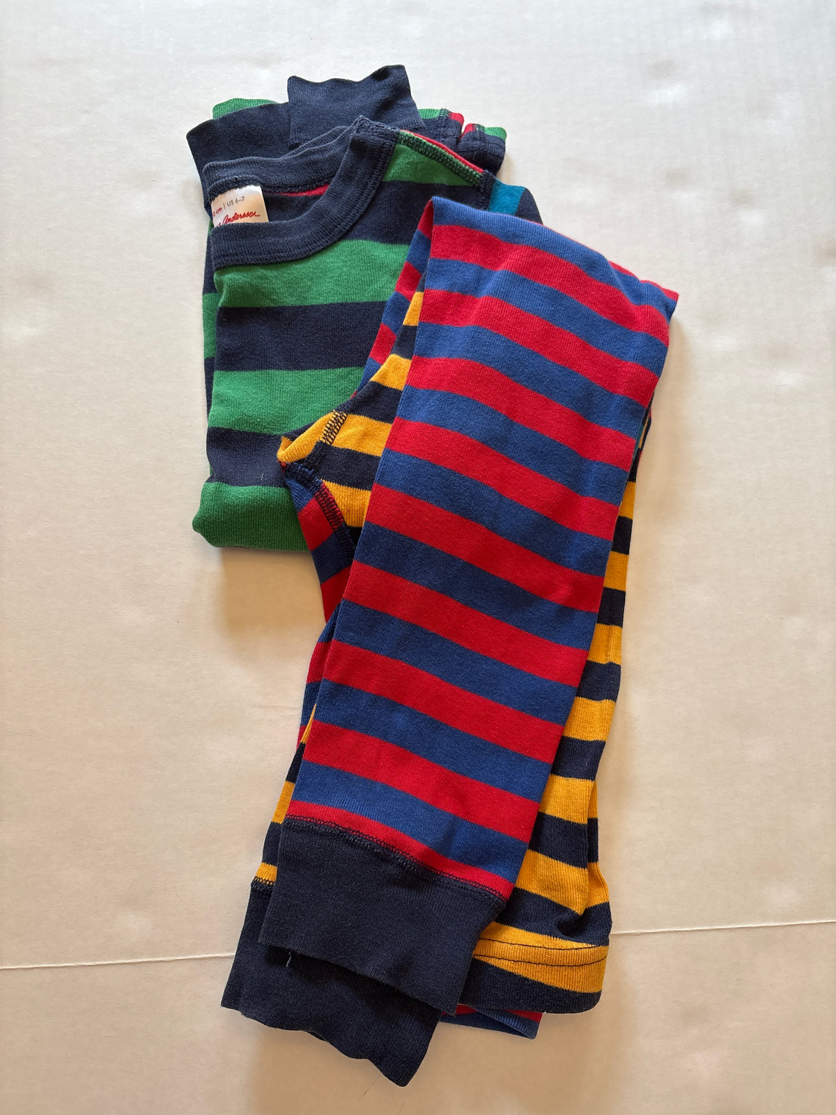 Seller 118. VGuC Boys Hanna Andersson Striped Pajamas. Size 6/7. Slight fade for dark colors.