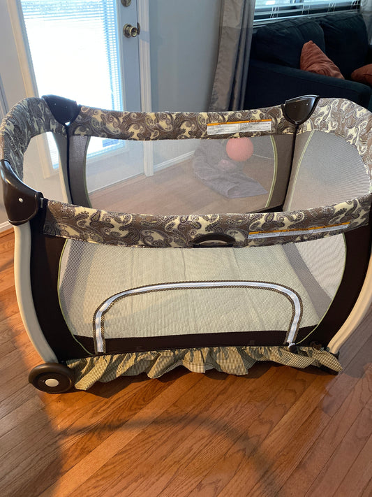 Seller #86 *REDUCED* Graco Pack n Play (brown and green paisley)