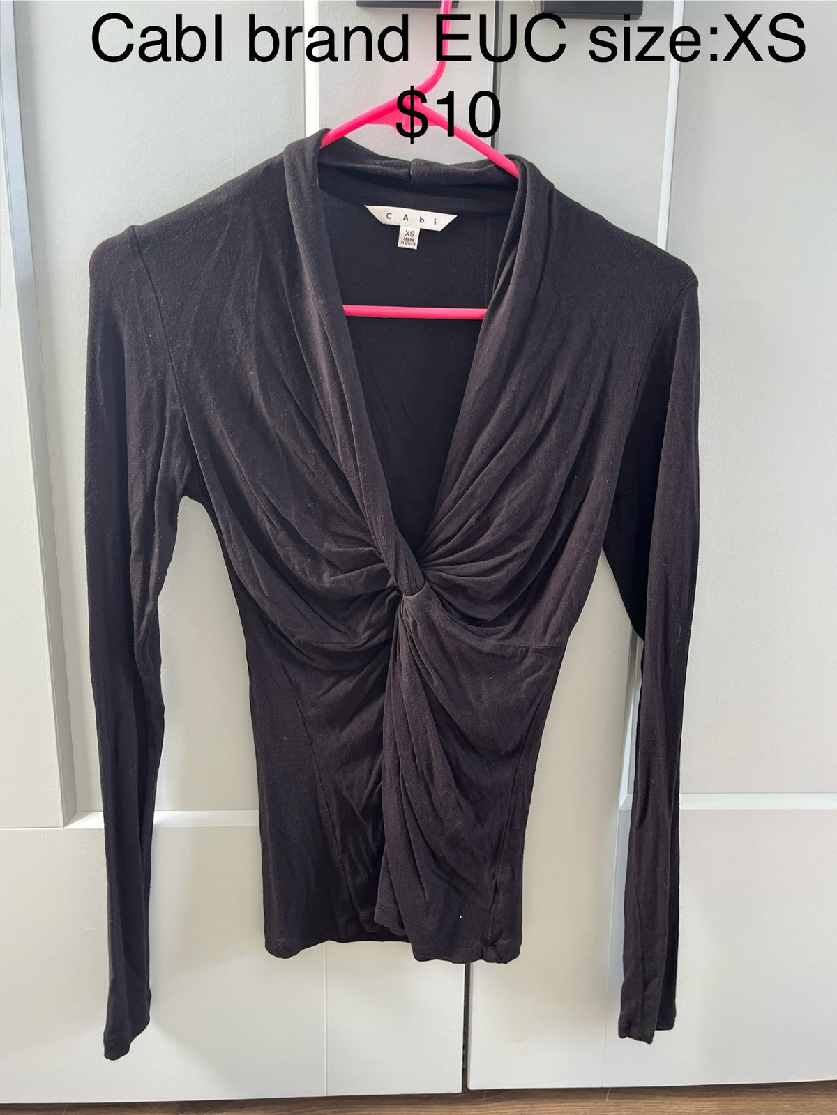 135 Cabi size xs, black form fitting v neck long sleeve, easy to dress up or dress down