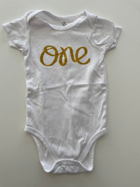 #117, 1st birthday white onesie w/ gold ‘one’ print,  Girls 12M