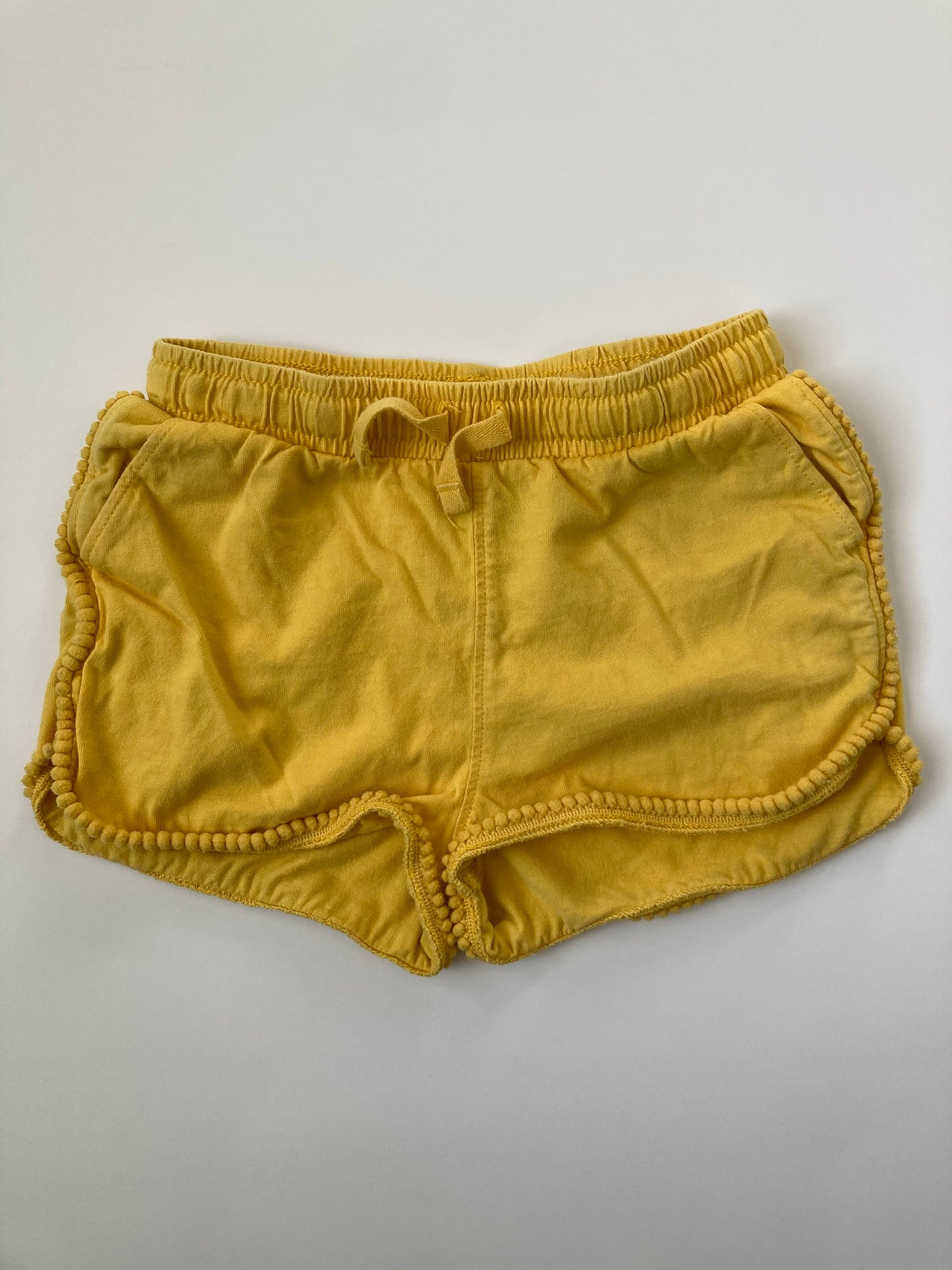 Tea Collection size 4 gold pom pom shorts