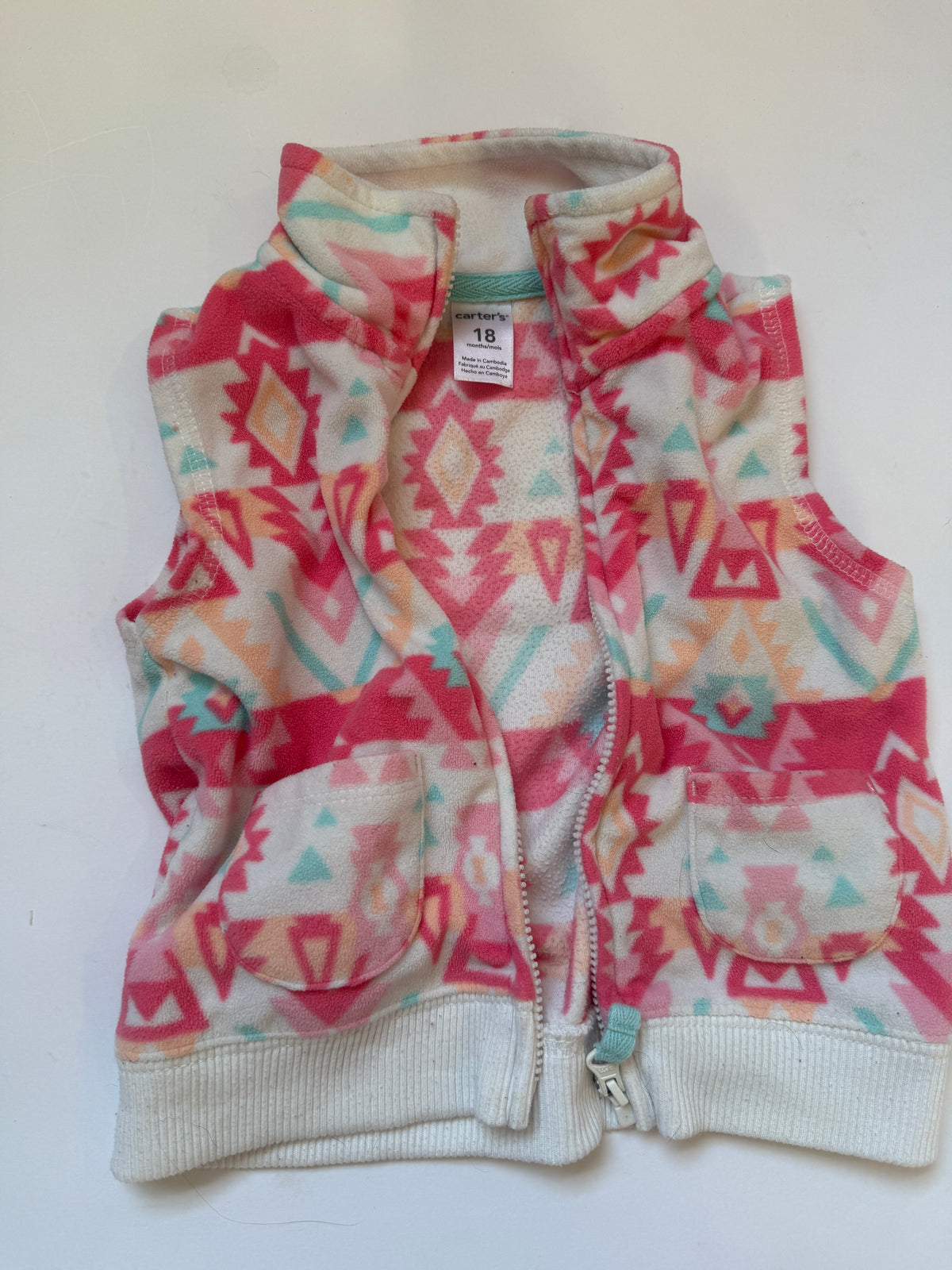 #170 Carters tops bundle (3)—pink with white polka dots and white little pockets, burgundy top with ruffle neck and fleece printed vest girls 18 months
