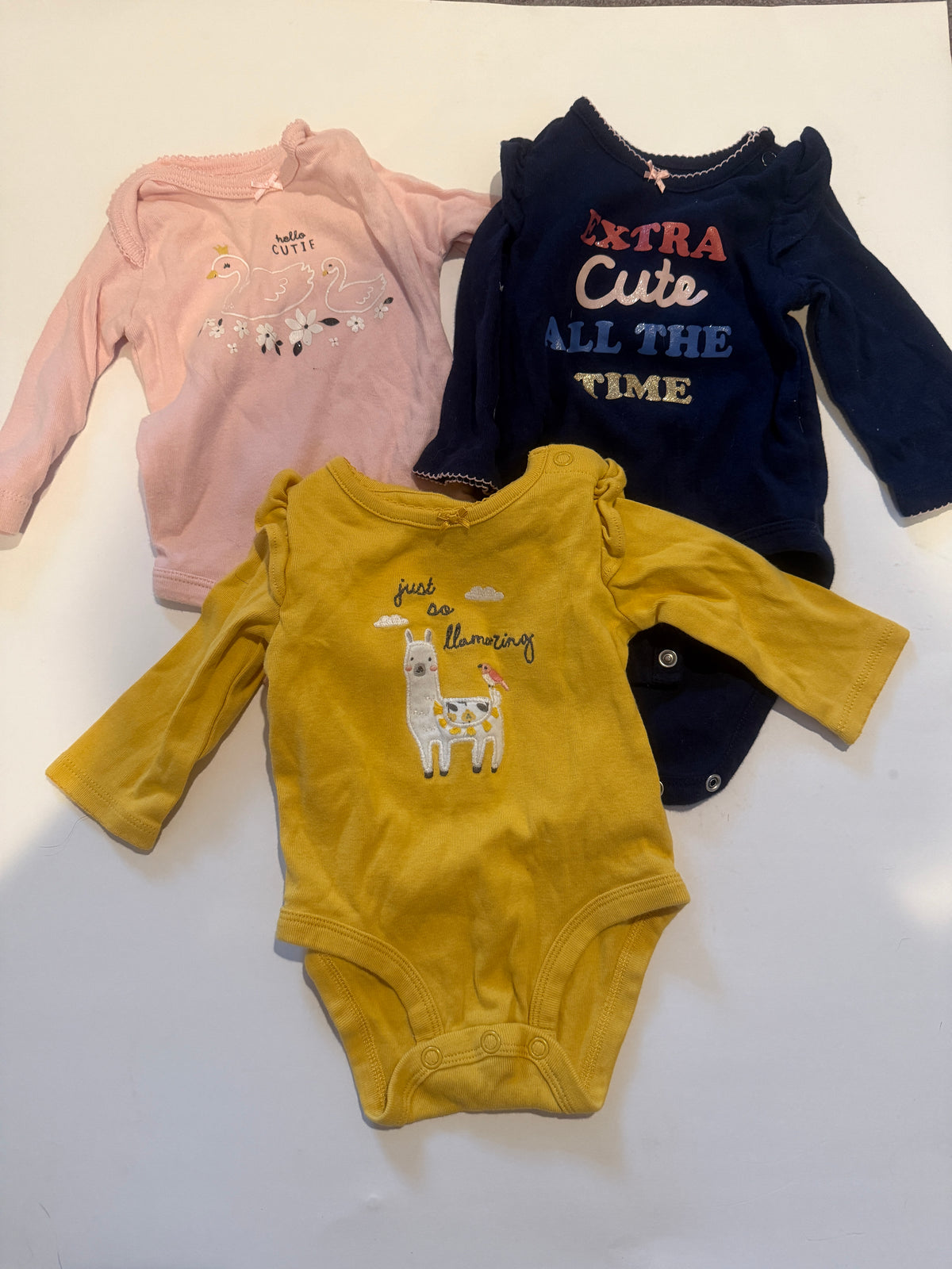 #170 Carter’s body suit bundle (3)—yellow “Just so Llamazing: with llama, navy riddle sleeve “Extra cute all the time” and pink swans “hello cutie” girls 3 months