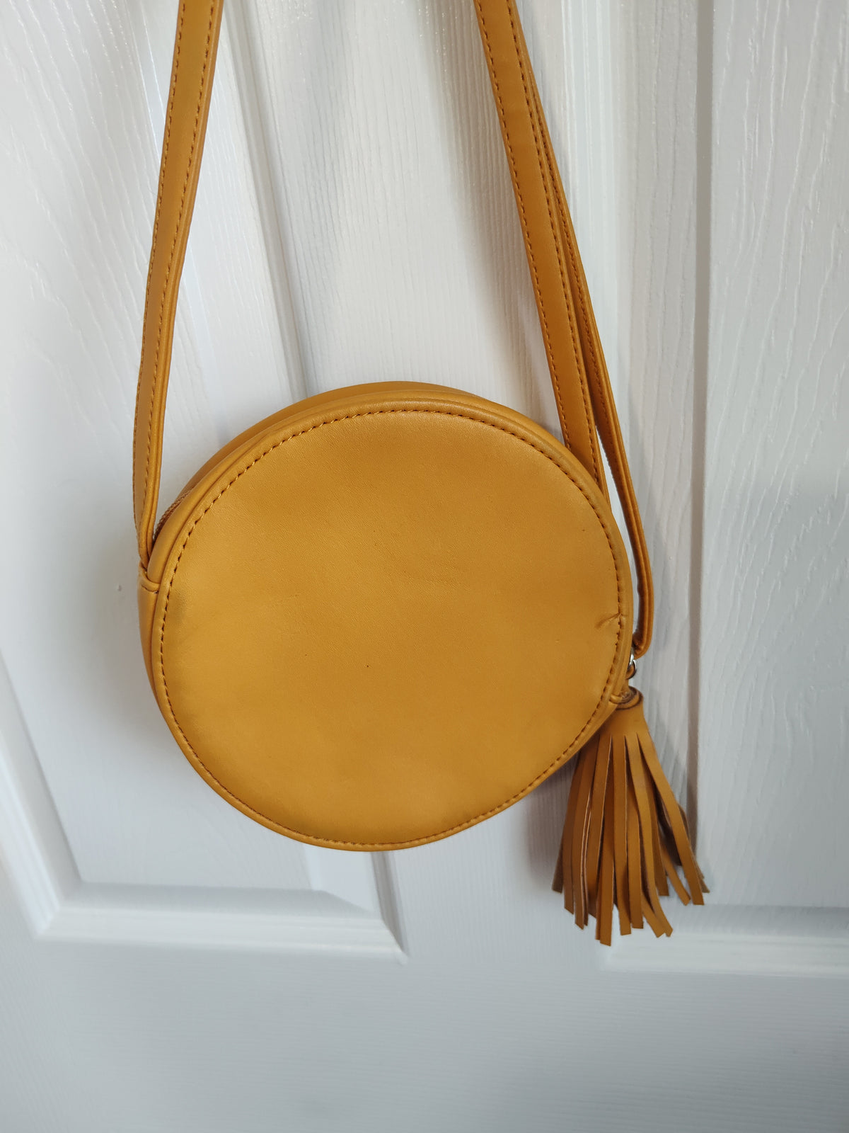 Seller 189:  Girl's mustard color round purse