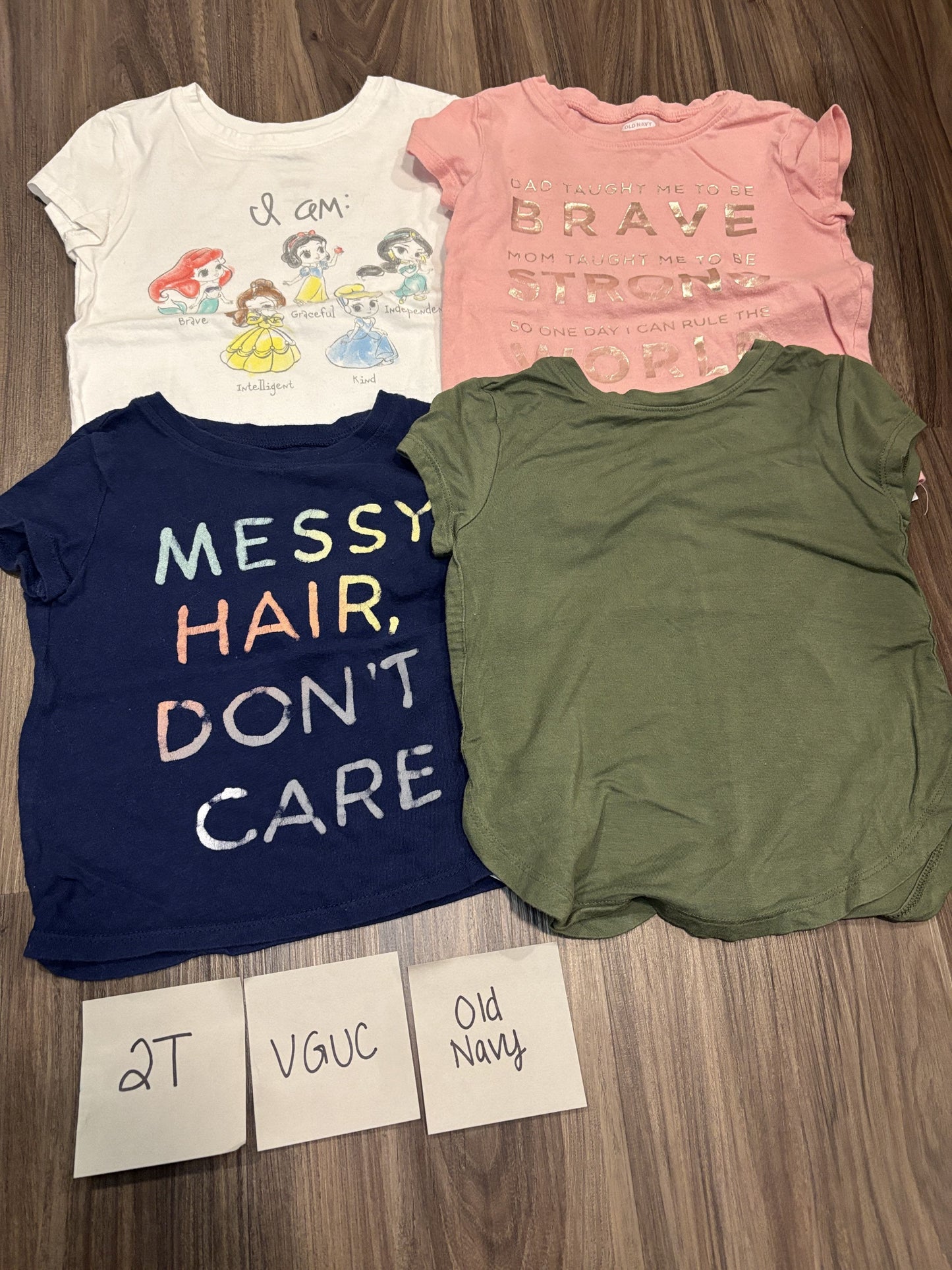 #77 - 2T - VGUC Old Navy - 4 Shirts (Princess, brave/strong, messy hair, green)