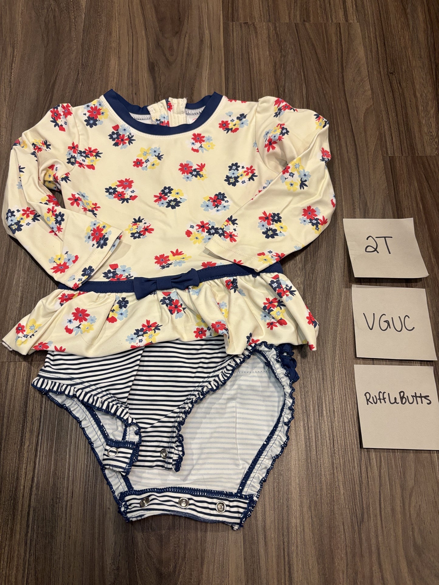 #77 - 2T - VGUC RuffleButts - Navy Floral Rashguard