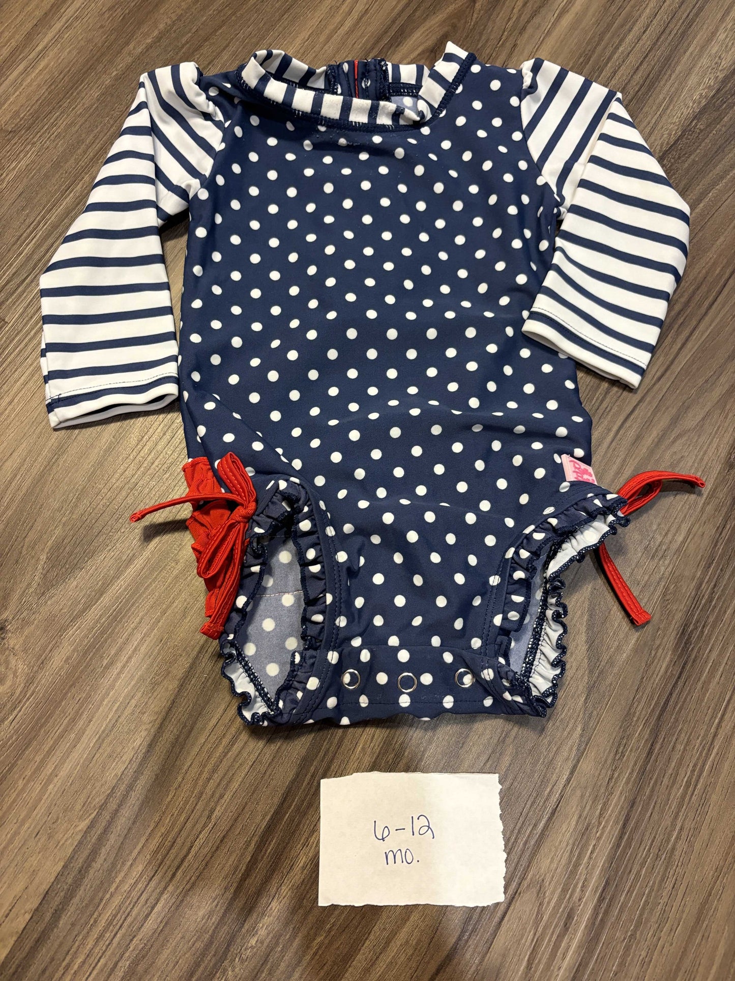 #77 - 6-12 Mo - VGUC RuffleButts - Navy Dot Rashguard