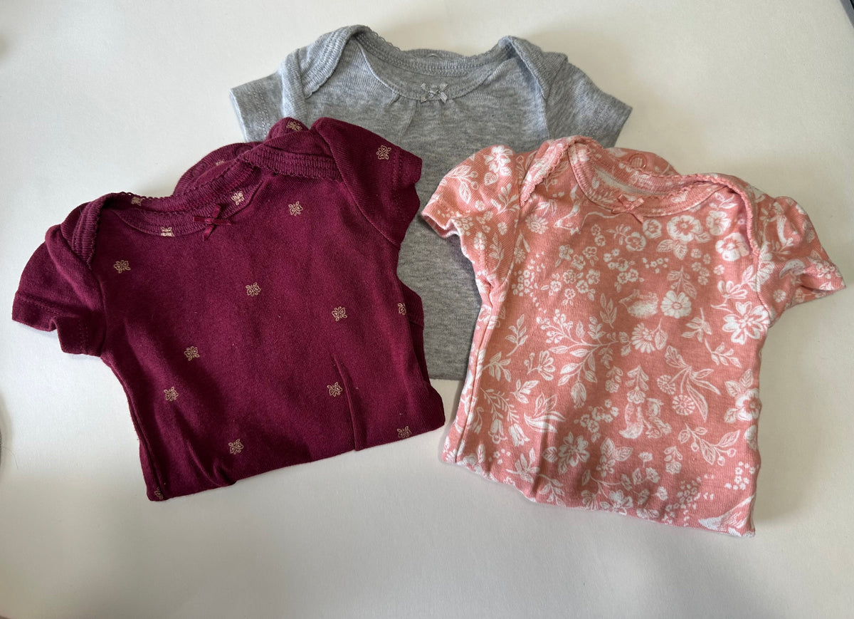 Seller 182. Carters girls newborn onesies.