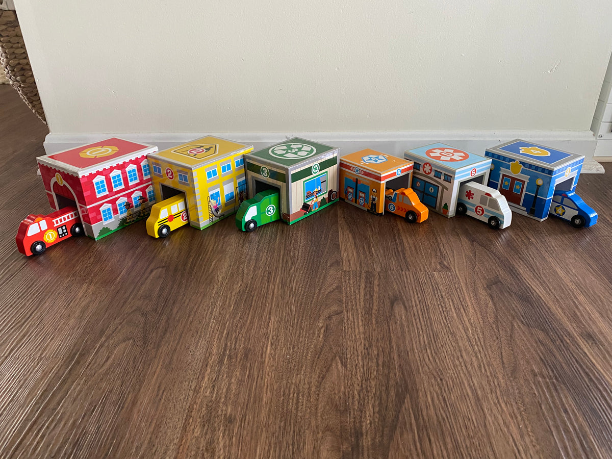 Seller 59 Melissa and Doug stacking/nesting garages with coordinating vehicles