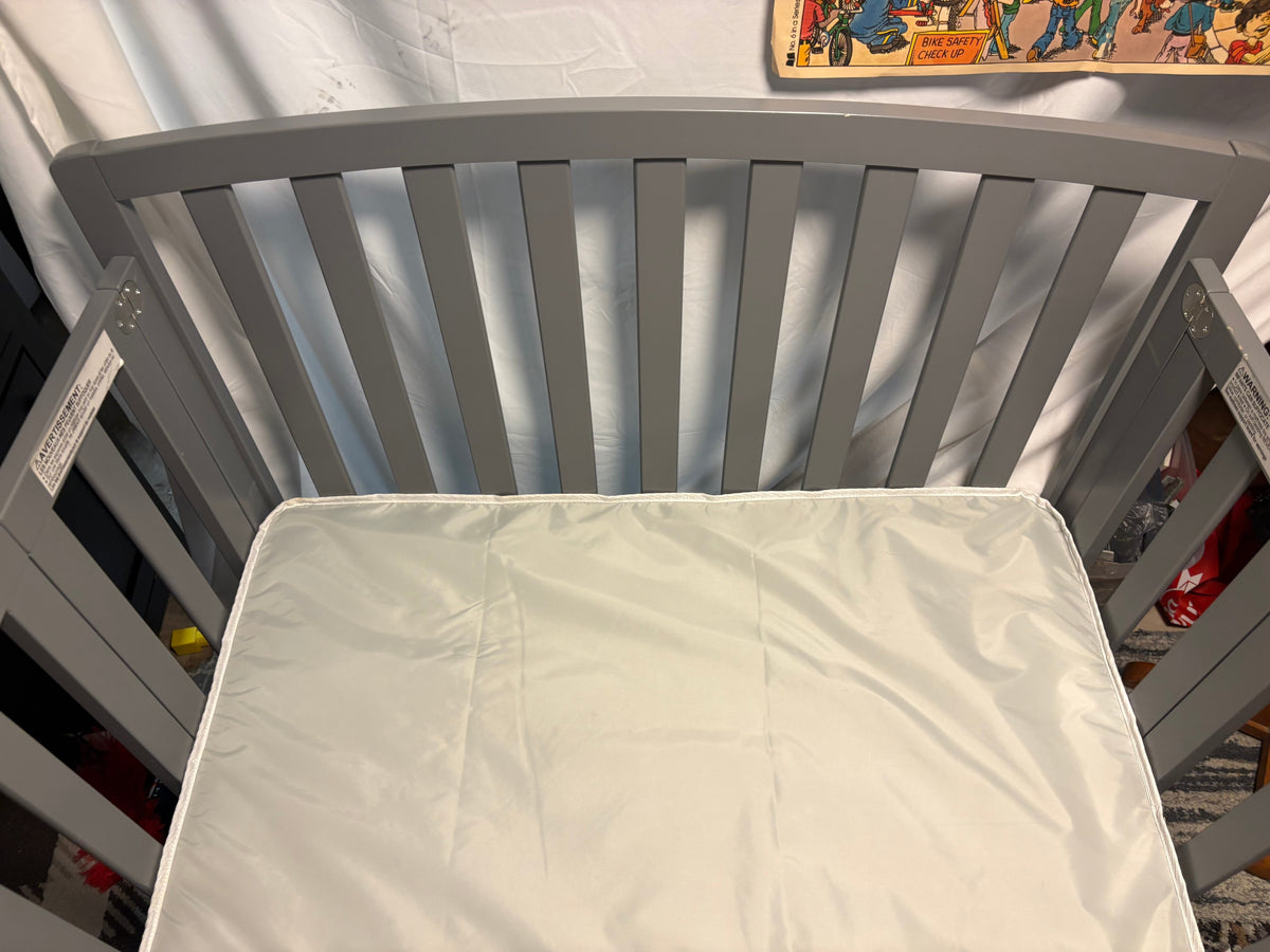 #34 Grey Delta Mini foldable crib with thick mattress