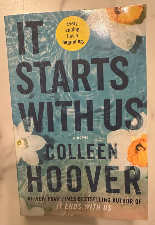 It Starts with Us paperback book by Colleen Hoover