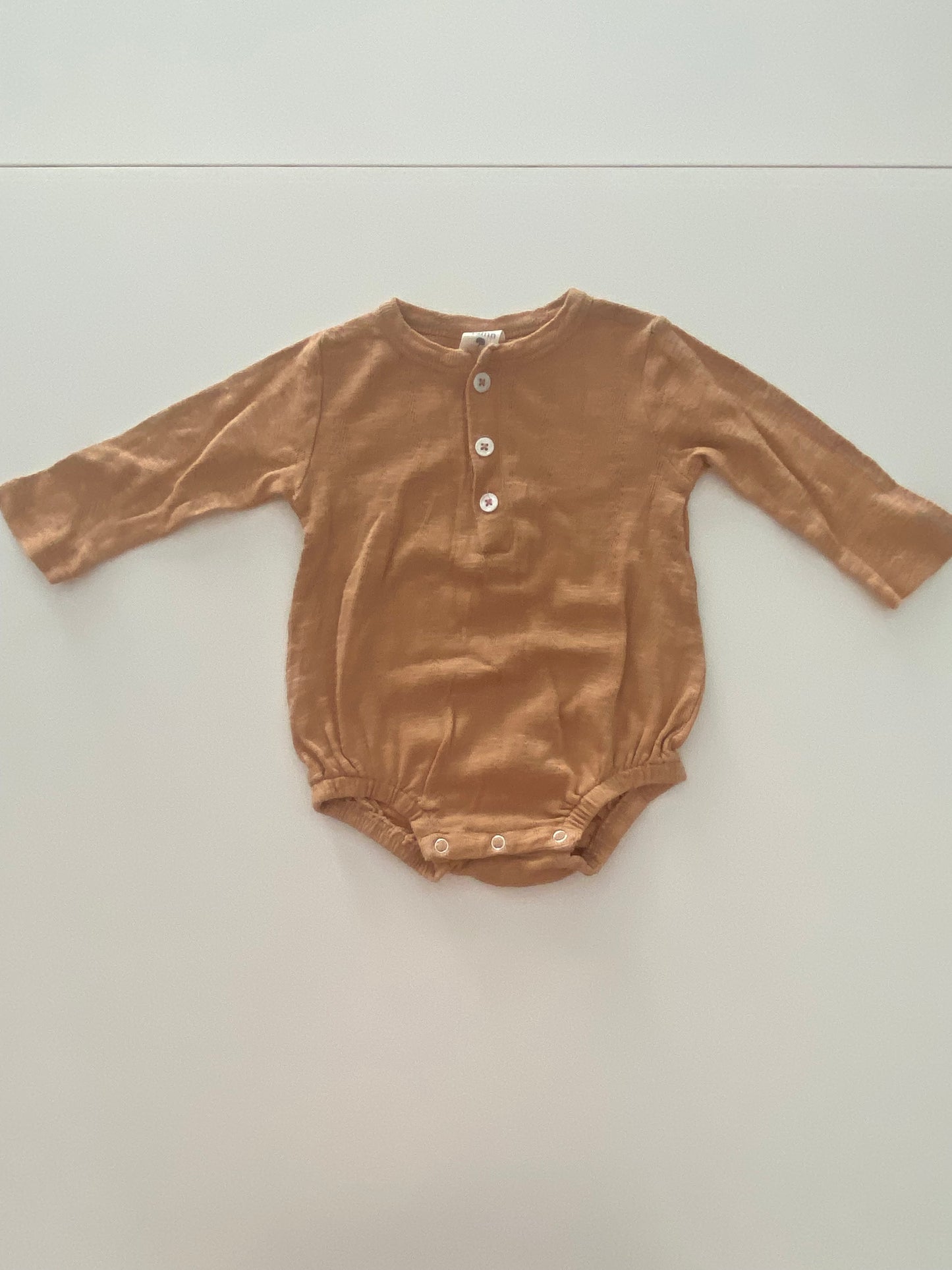 #117- Girls 12M, Kate Quinn tan onesie, VGUC