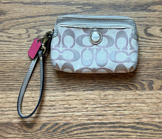 #74 Coach signature "C" print double-zip wristlet accented with a bright pink leather hangtag
