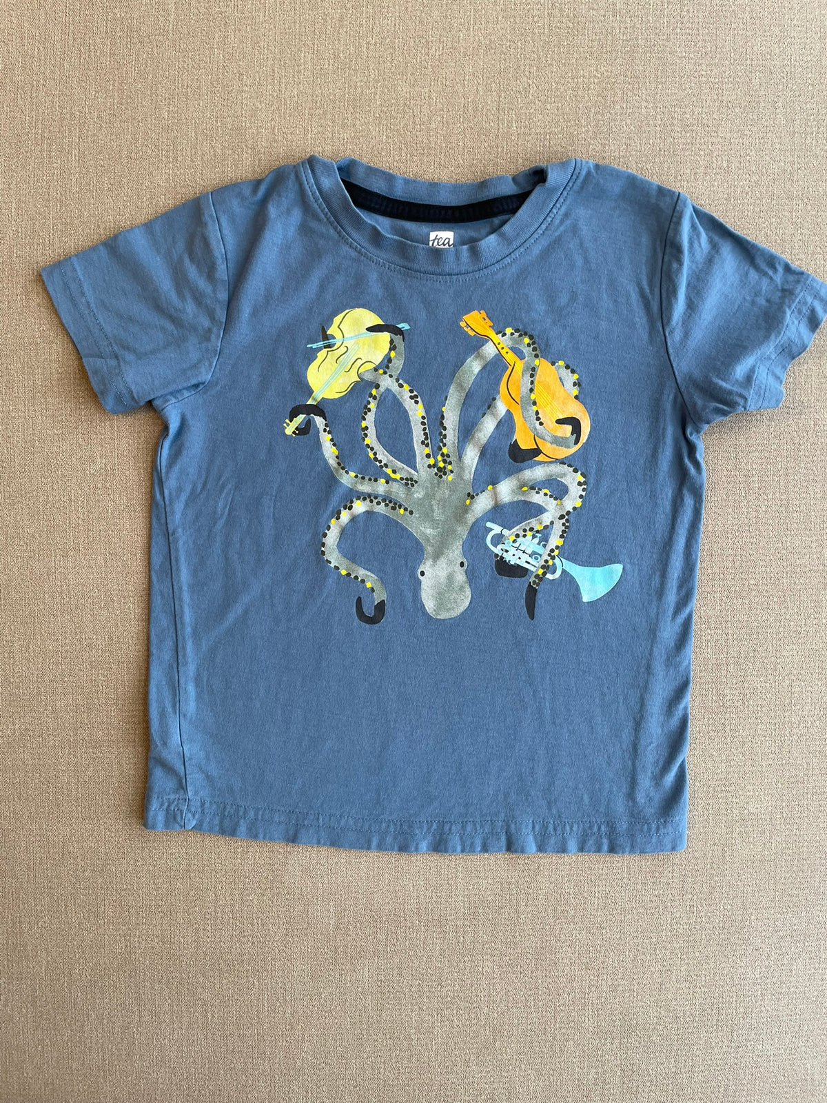 Seller #12 | Tea | Blue Tshirt with Upside Down Octopus Holding Instruments | VGUC | Size 4