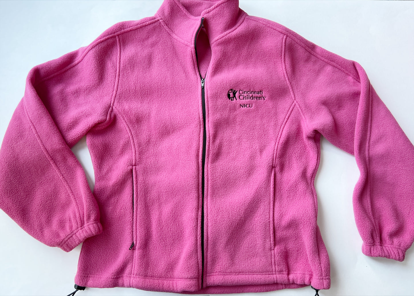 Cincinnati Children’s NICU pink fleece zip-up (old logo), size is ‘Ladies large,’ zippered pockets and drawstrings at the waist for adjustable fit, VGUC (worn once or twice)
