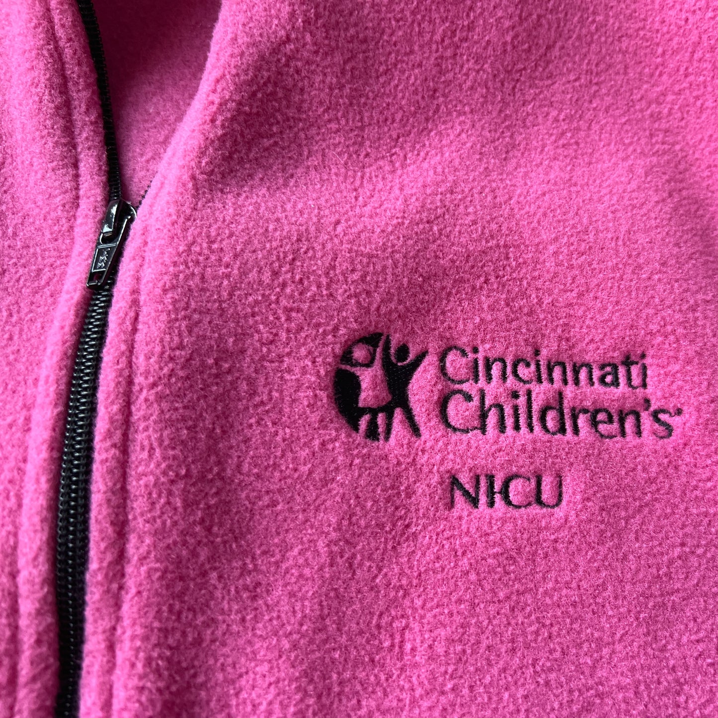 Cincinnati Children’s NICU pink fleece zip-up (old logo), size is ‘Ladies large,’ zippered pockets and drawstrings at the waist for adjustable fit, VGUC (worn once or twice)
